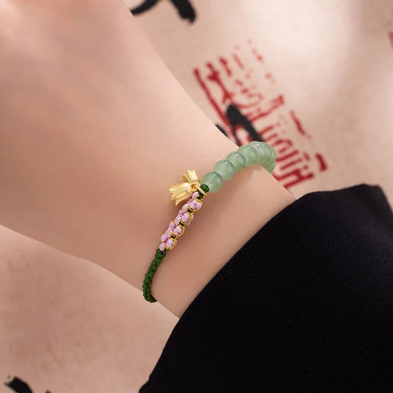 Red rope hand woven women's bracelet with floral decorative elements in BZ479 colour