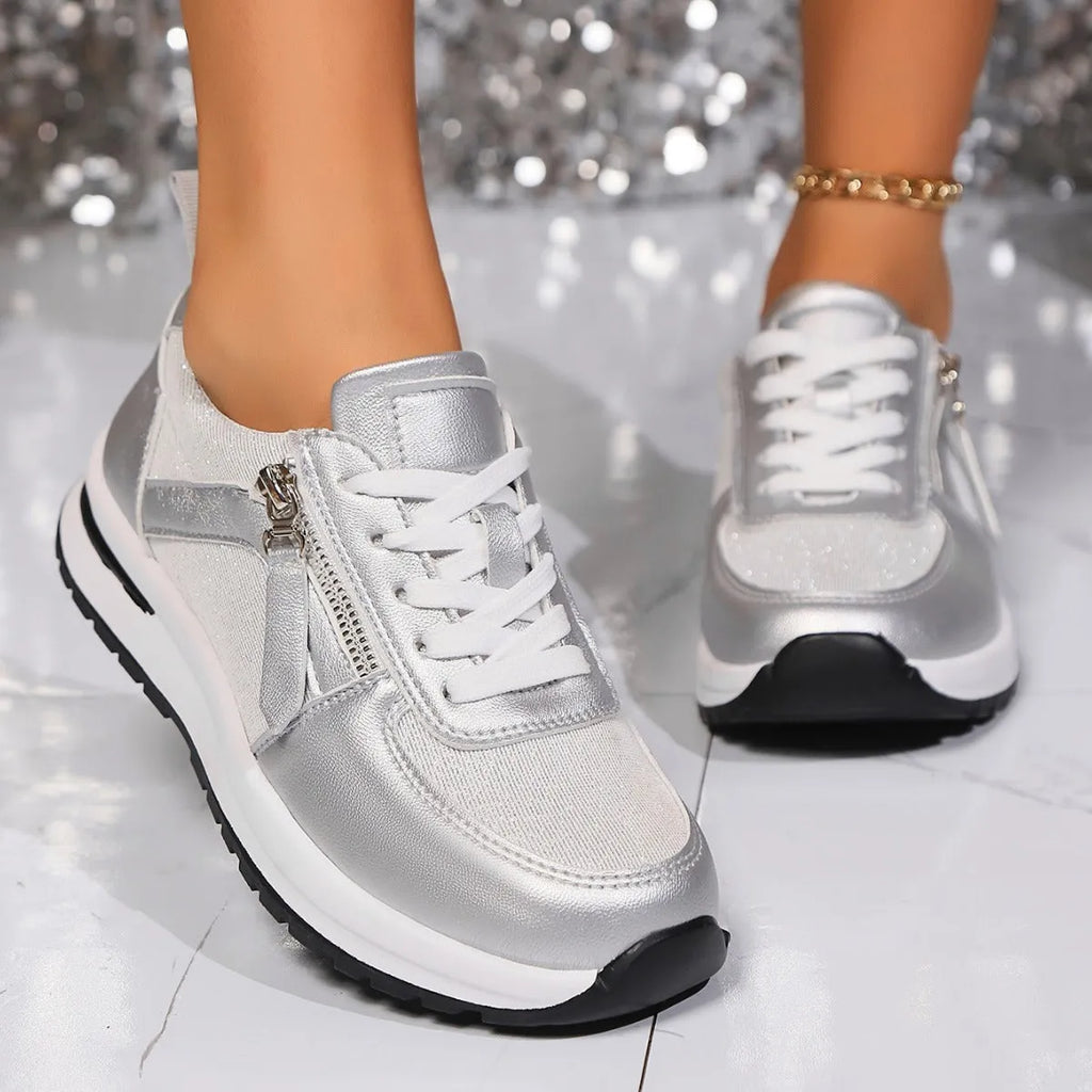 Gold women's flat sole lace-up pumps with round toe on a white background.