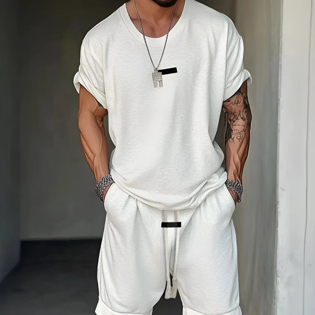 Men's hip hop style grey T-shirt with letter printing and matching shorts on a hanger.