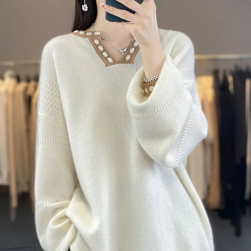 Women's camel coloured V-neck long sleeve pullover sweater on a hanger.