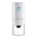 Black portable electric coffee grinder with transparent chamber showing coffee beans, USB-C charging port visible