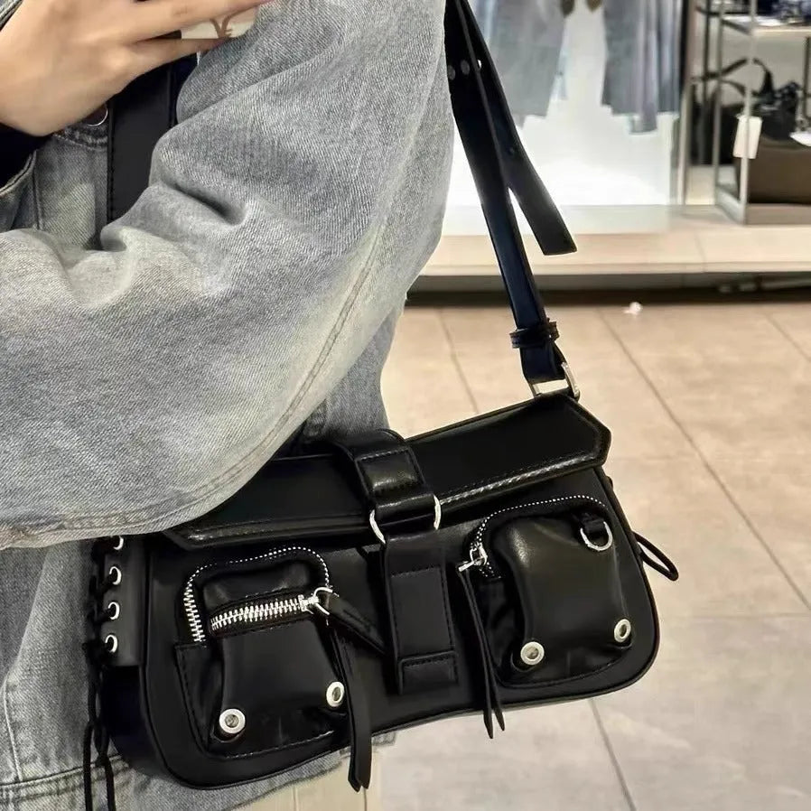 Black women's messenger bag with adjustable shoulder strap showing zipper pocket interior