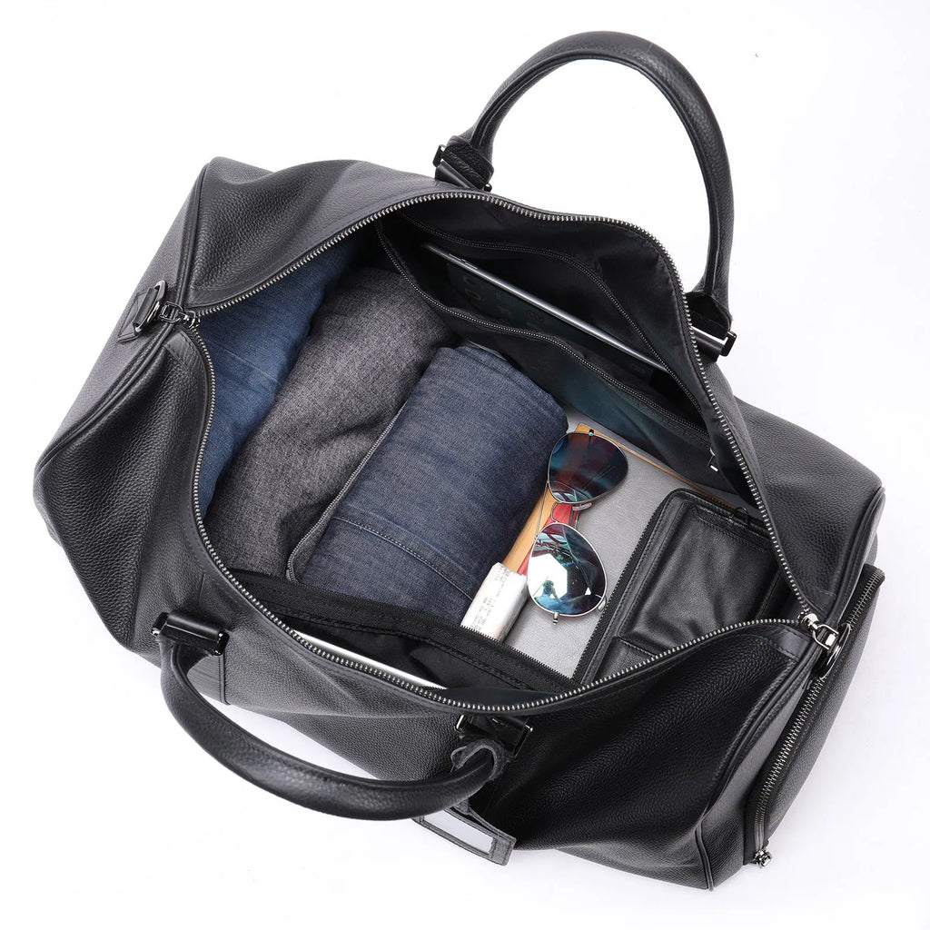 Men's black leather excursion bag showing single strap and large capacity design