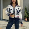 White women's cardigan with front zipper, lapel collar, and jacquard weave pattern
