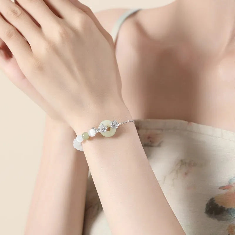 Pure silver peach blossom bracelet for women with a safety buckle in a gold electroplated finish.