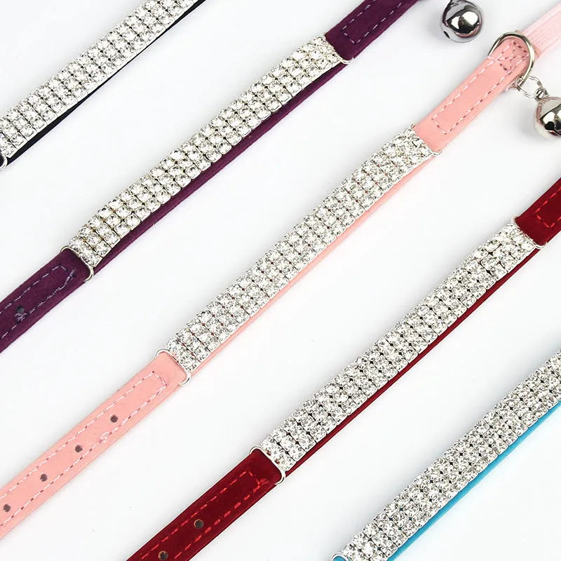 A red velvet cat collar decorated with rhinestones, showing its adjustable length design.