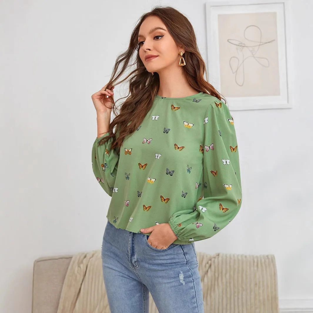 Women's green long-sleeved shirt with butterfly print pattern and loose fit.