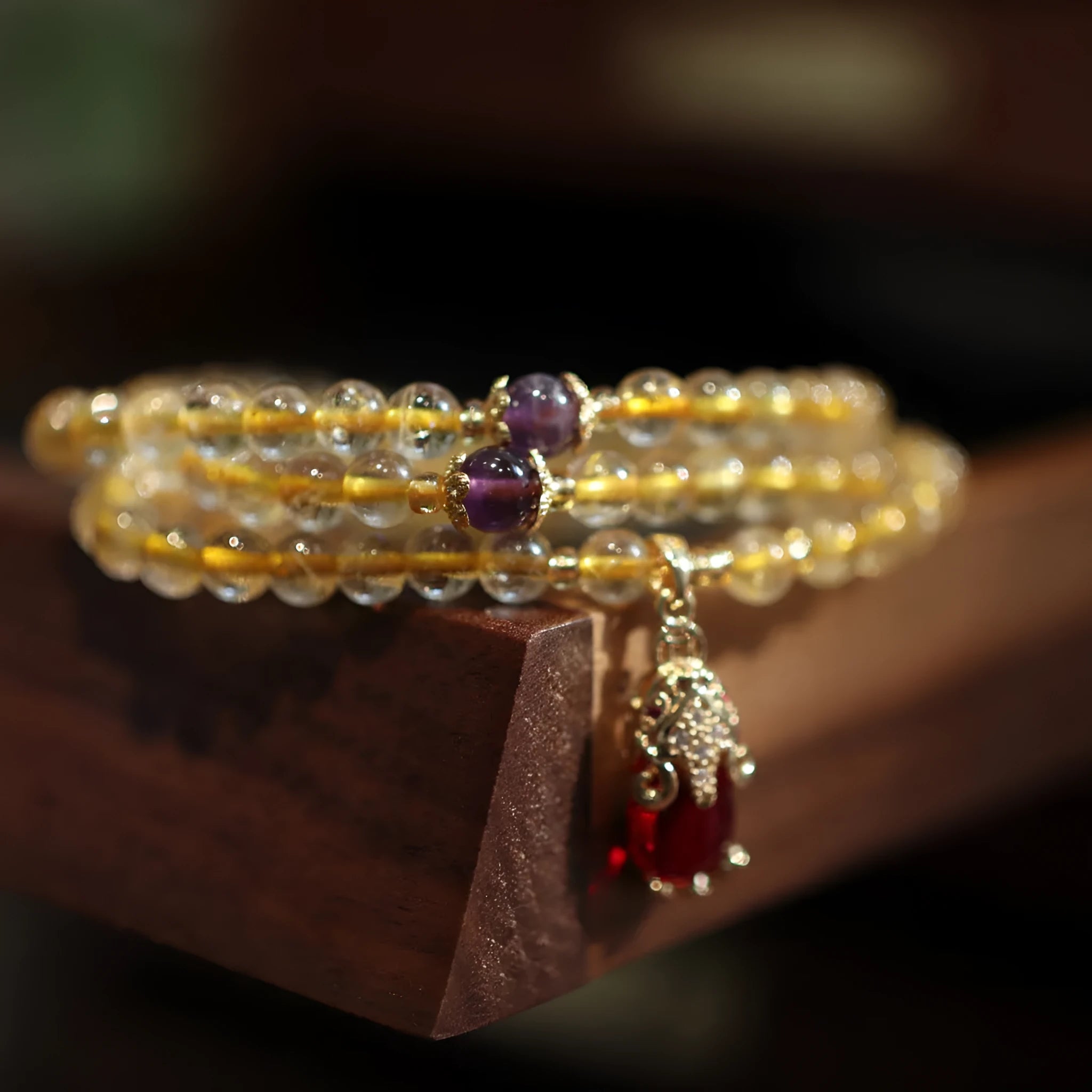 Handmade natural gold rutilated quartz bracelet in Chinese three-ring style with hanging chopsticks.