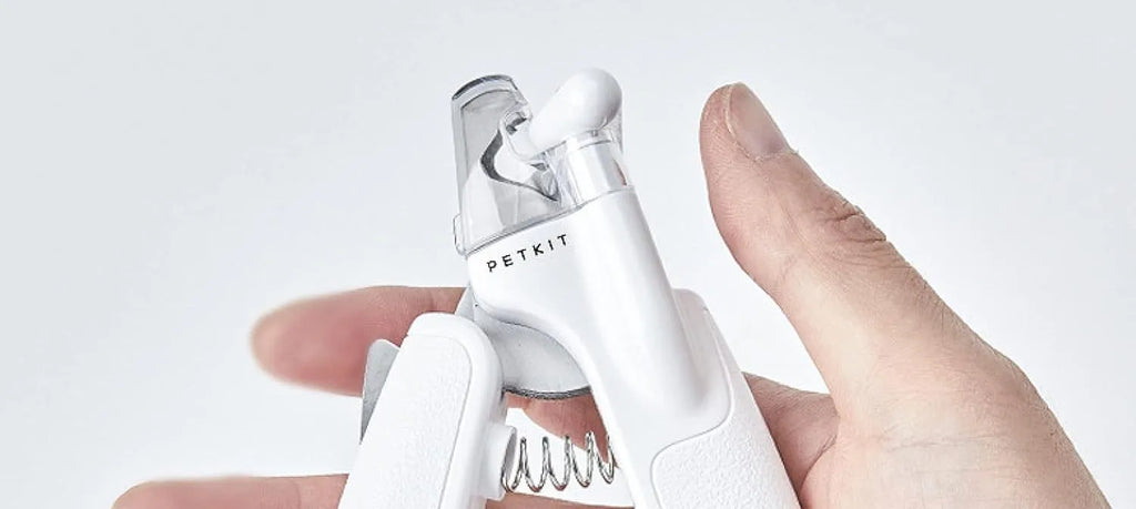 White pet nail clippers with LED light, transparent guard, and built-in file for cats and dogs.