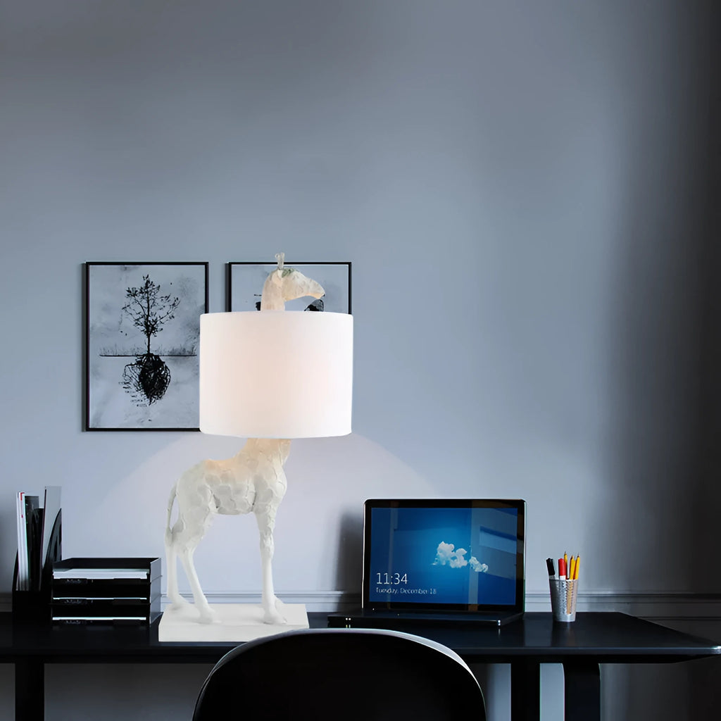 White or gold giraffe table lamp measuring 66cm tall with resin and cloth construction