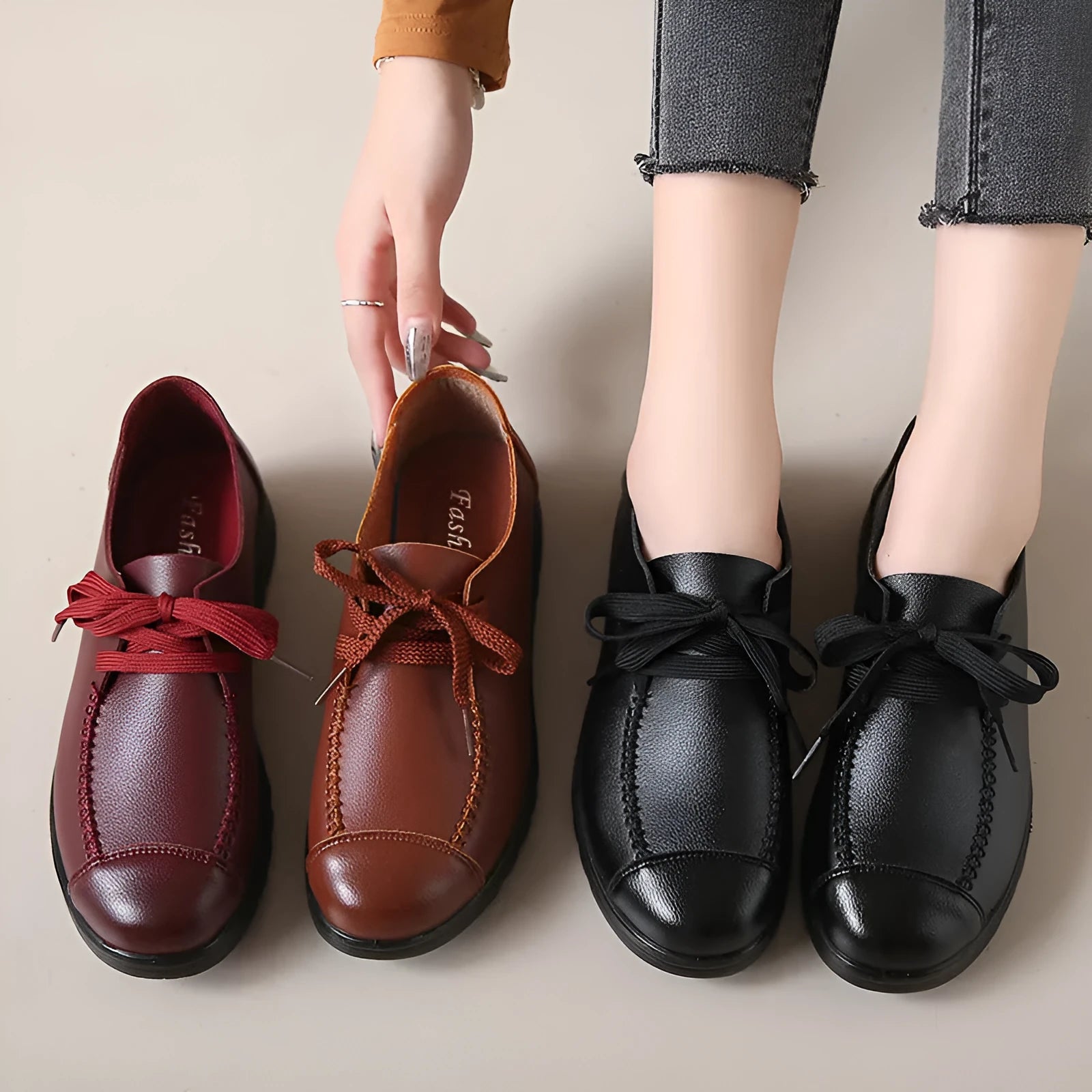 Women's black round toe flat work shoes with front lacing and soft anti-slip polyurethane sole