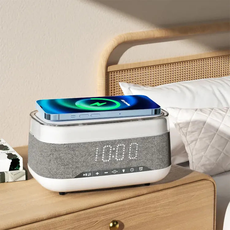 White multifunctional alarm clock unit with Bluetooth speaker and wireless charging pad.