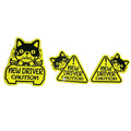 Set of three magnetic reflective car stickers showing cat, panda and duck designs on a car window.