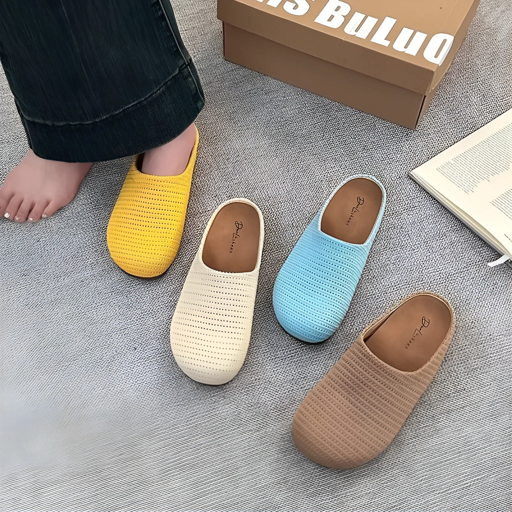 Women's blue cloth slippers with round toe and non-slip rubber sole, shown from the side.