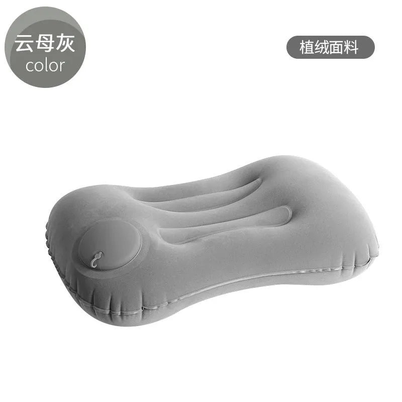 Grey inflatable travel pillow with flocking finish shown inflated to 45x30x13cm dimensions for neck support