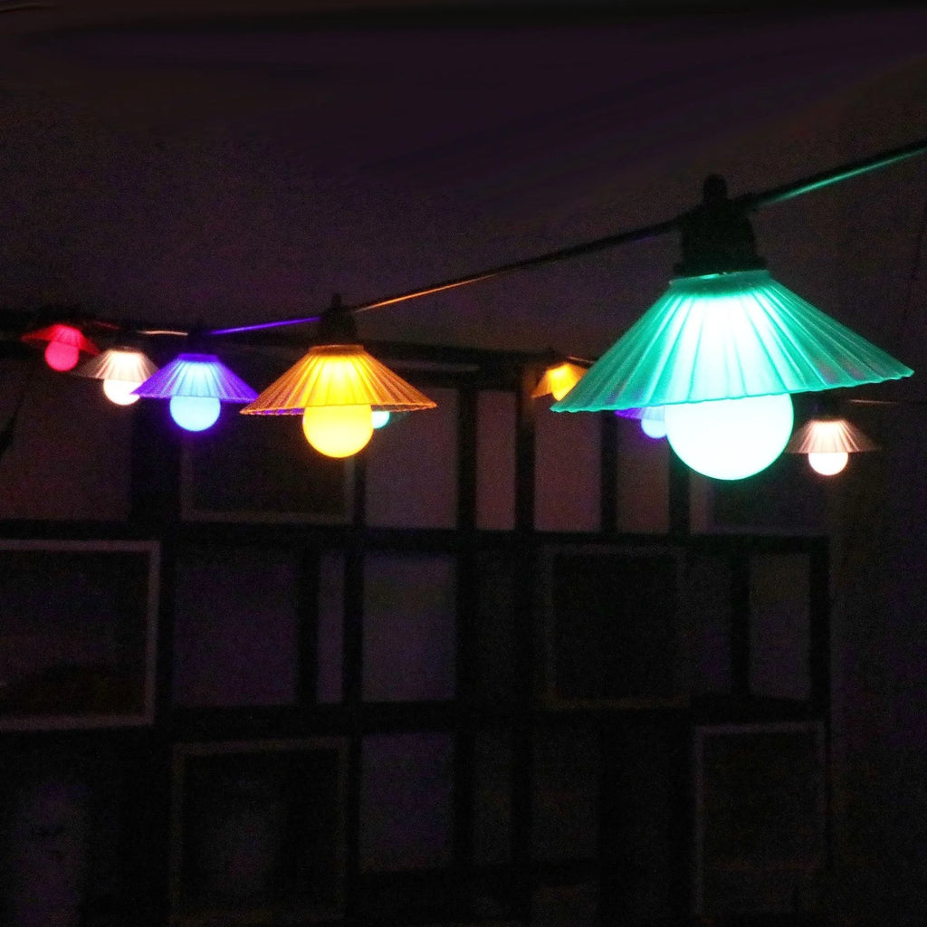 Outdoor LED string lights with flower-shaped bulbs in four colours or warm white, IP65 rated.