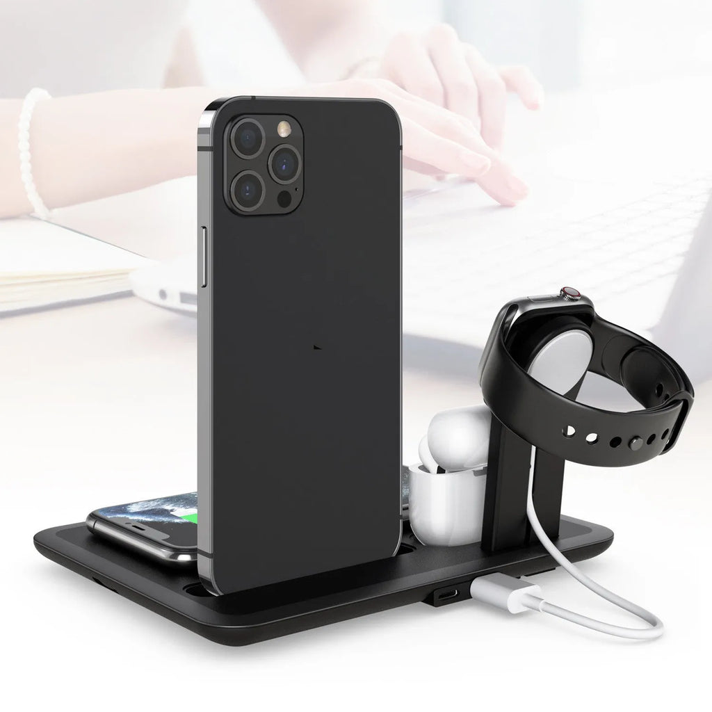 Black multi-device wireless charging station for phone, smartwatch, and headphones on a wooden desk.