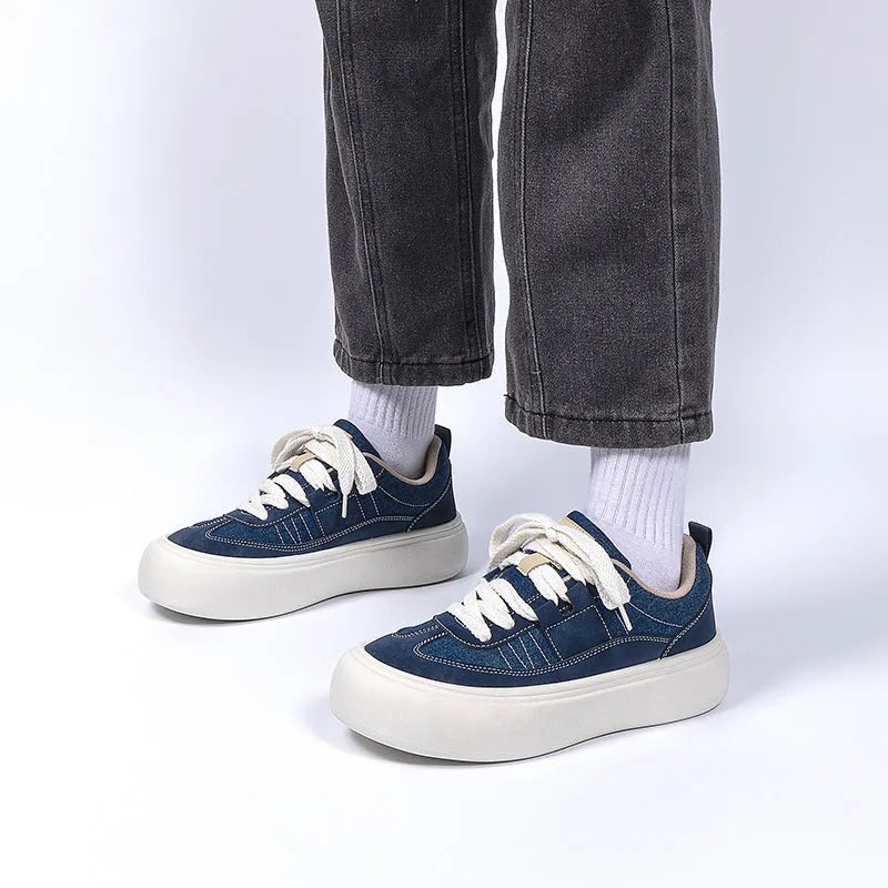 Men's black platform canvas trainers with lace-up front and raised sole on a white background