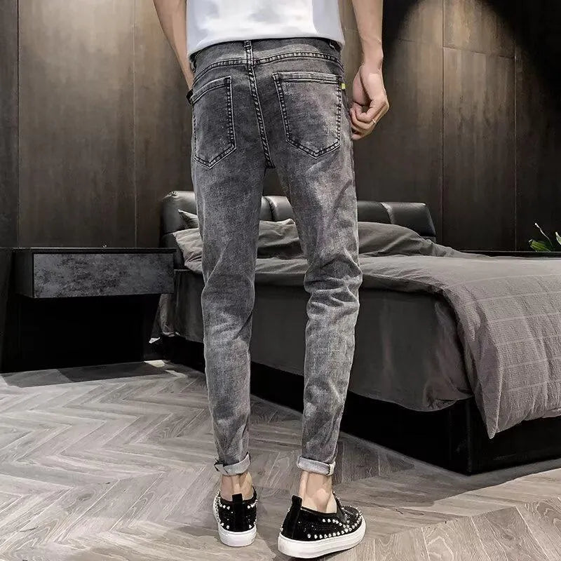 Man's high-waist blue denim jeans with a button fly on a plain background.