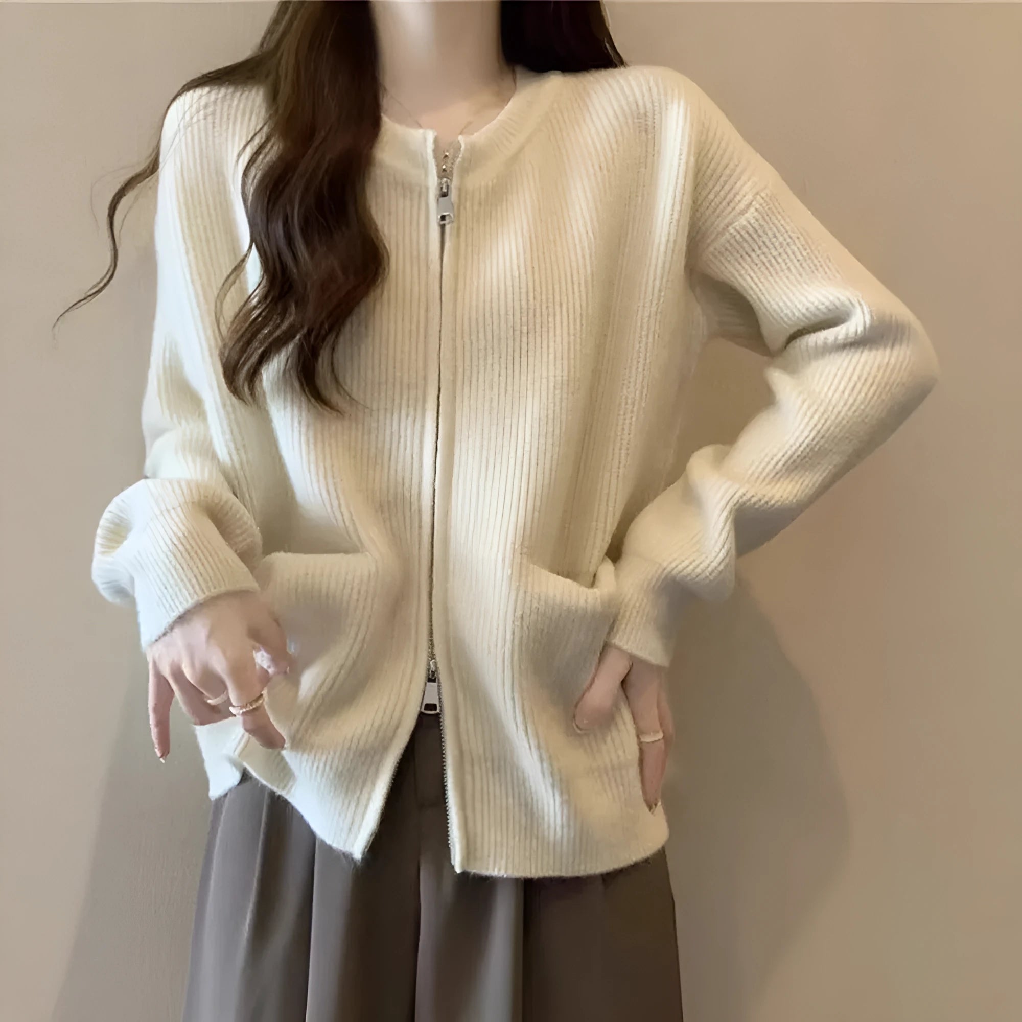 Beige viscose fibre long-sleeve sweater coat cardigan laid flat, showing soft drape and button front.