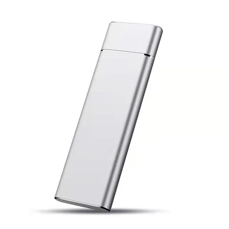 Ultra-thin silver metal external hard drive with data cable on a desk.