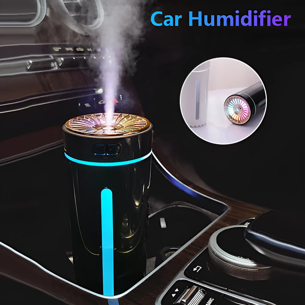 Black and white portable USB rechargeable car humidifier with colourful LED lights on a desk.