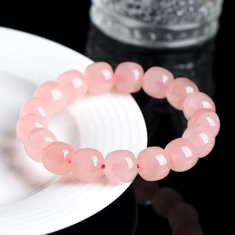 Pink crystal barrel bead bracelet with geometric design and polished finish