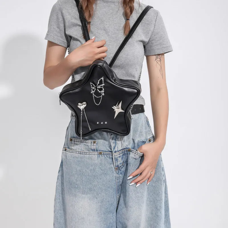 Black street trend backpack with metal butterfly pendant and chain details.