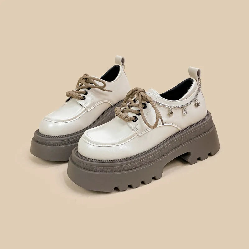 White women's platform Mary Jane shoes with a chunky heel and front lace-up fastening.