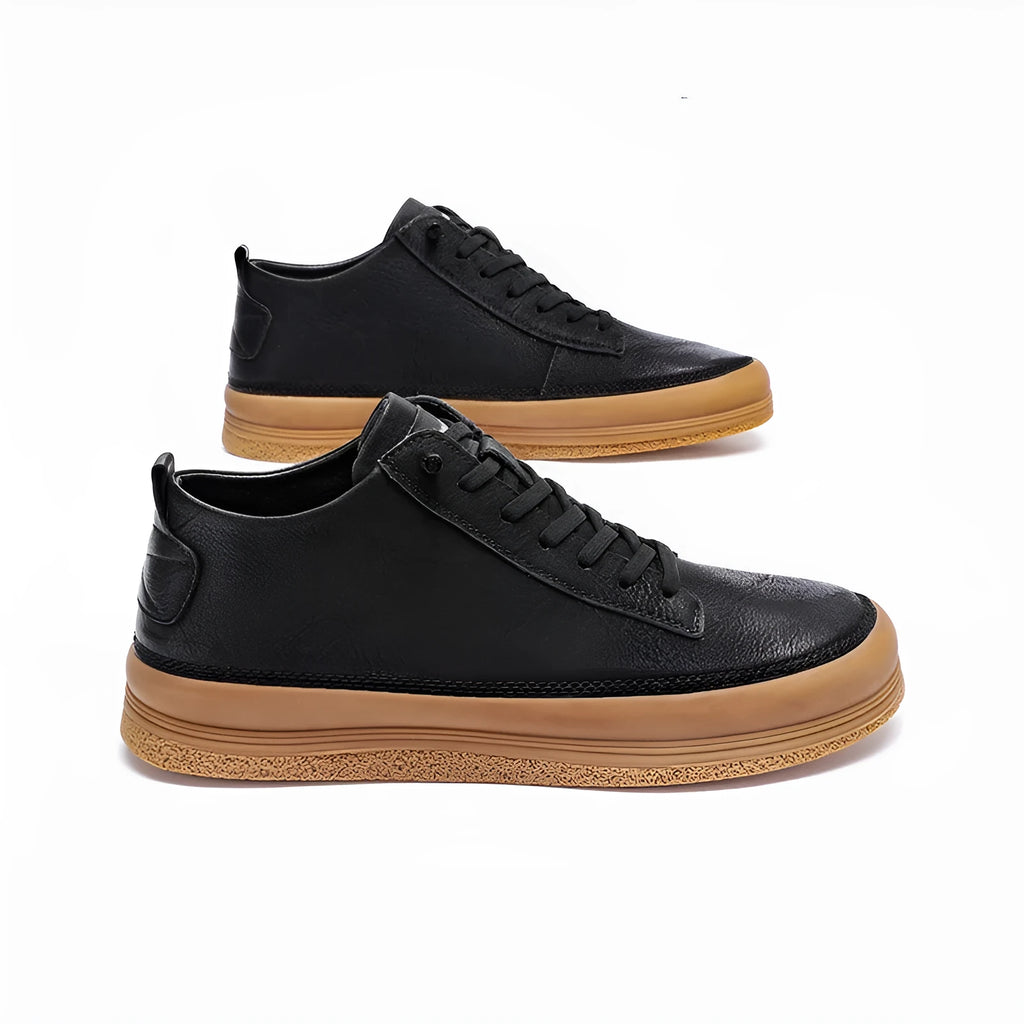 Men's black leather casual shoes with round toe and white flat rubber sole on a plain background