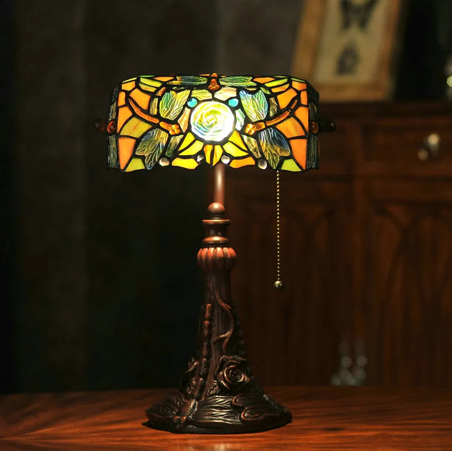 10-inch Tiffany style desk lamp with coloured stained glass shade and matching resin base on a wooden table.
