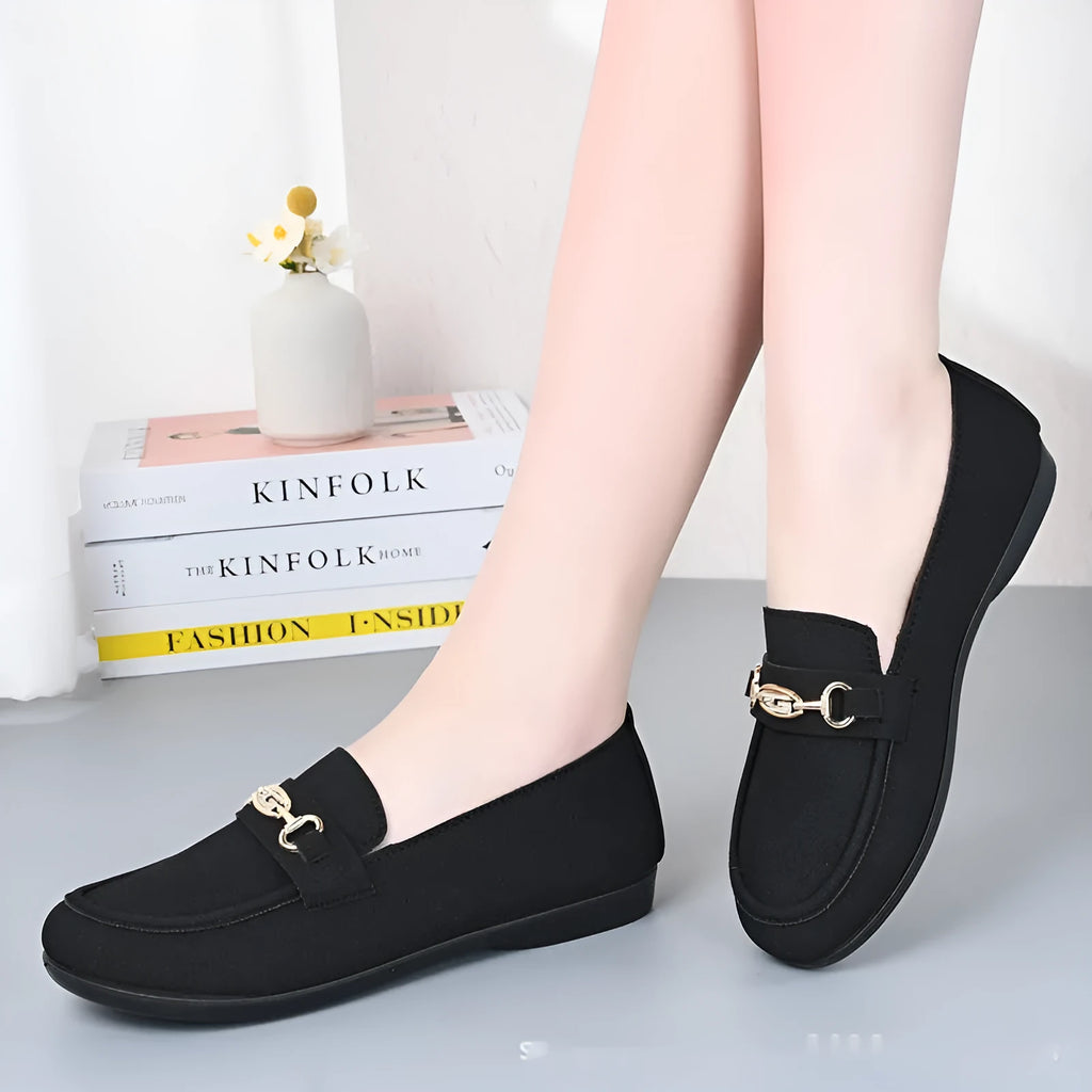 Gommino women's black slip-on casual shoes with a round toe and soft rubber sole on a white background.