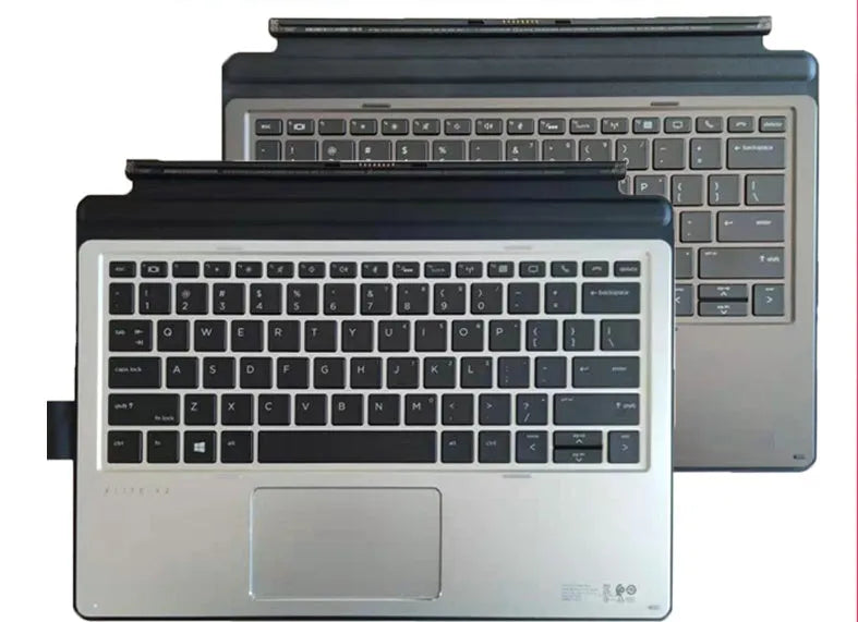 Elite X2 tablet base keyboard with PS/2 cable and multimedia keys on a table next to a thin tablet.