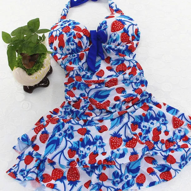Women's blue strawberry print one-piece swimsuit with cross straps and push-up support.