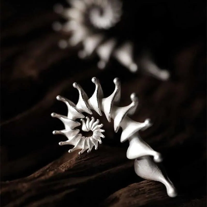 Exaggerated three-dimensional conch stud earrings with matte electroplated alloy finish