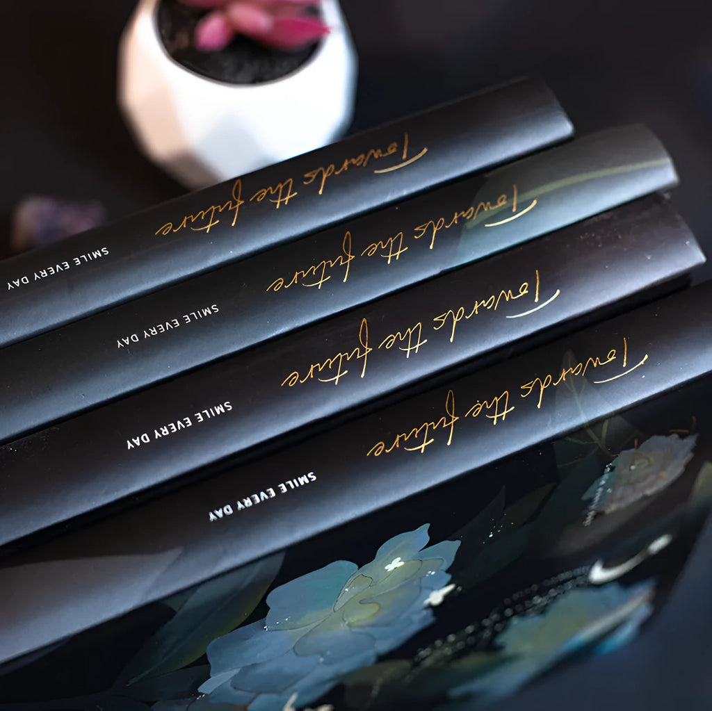 A5 notebook with luminous cover open to show colour illustrated interior pages
