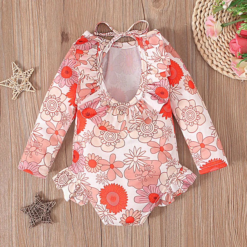 Girl's floral print open back swimsuit in orange red, shown from front and back.