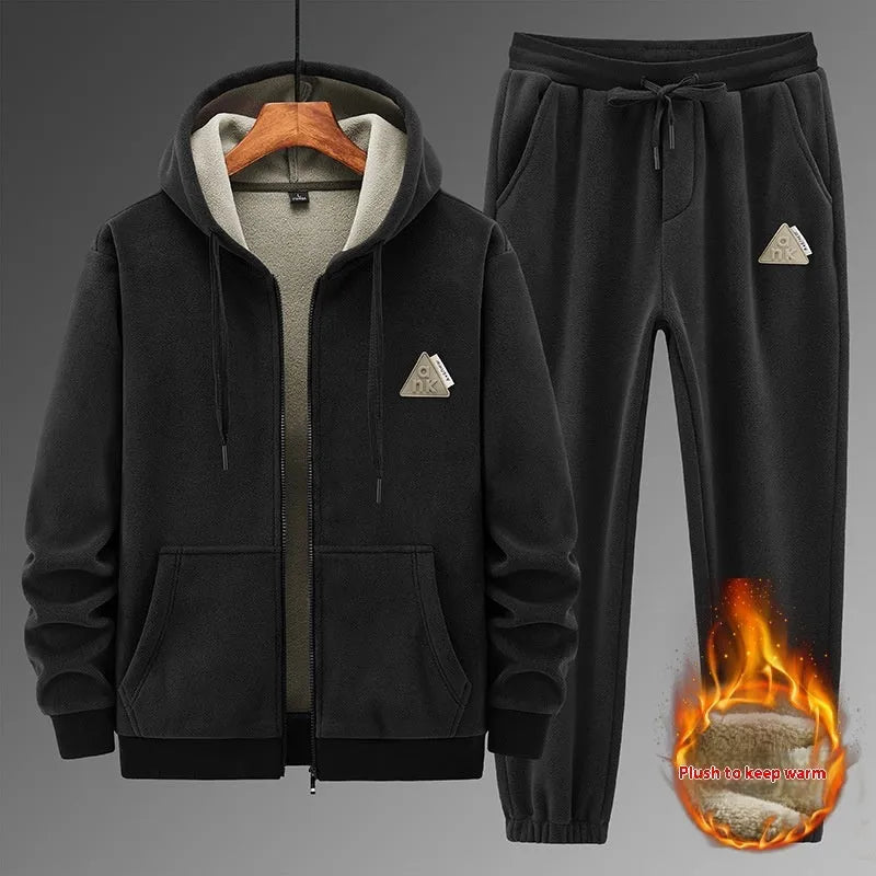 A grey men's casual sports suit featuring a hooded sweater and matching trousers on a hanger.