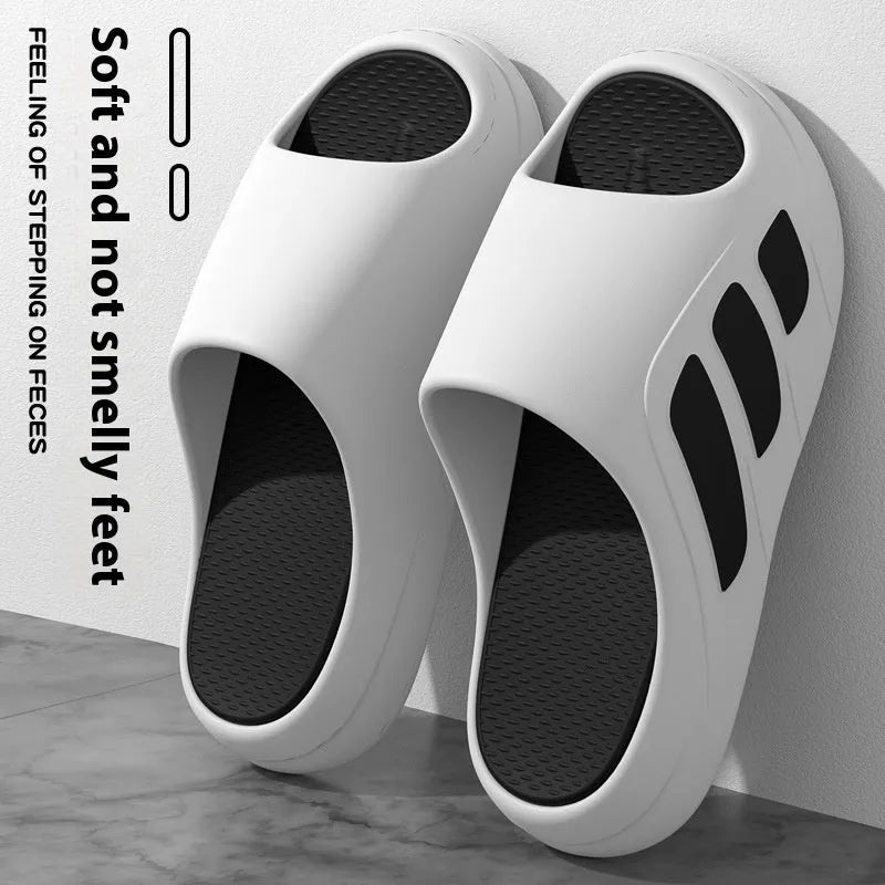Brown and black two-tone EVA platform slippers with injection moulded soles on wooden floor