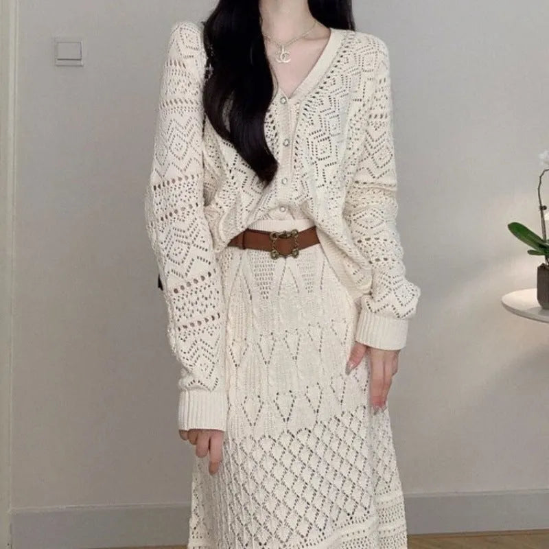 Beige two-piece set with hollowed-out knit top and mid-length lace-up skirt and belt