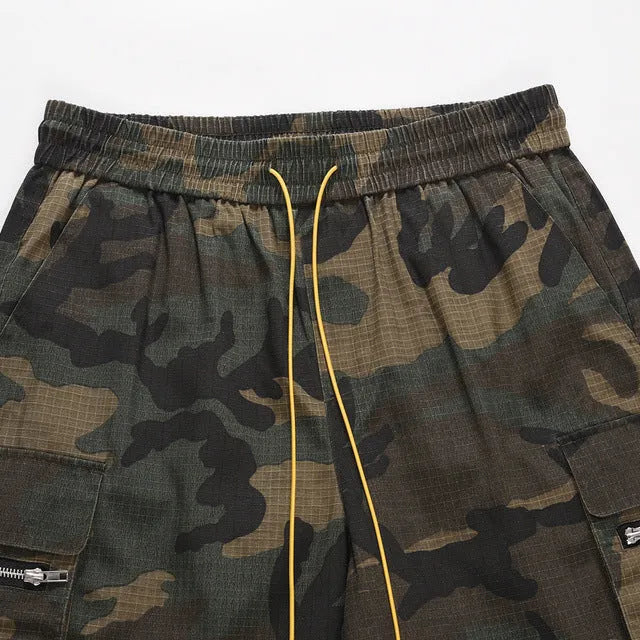 Men's green washed camouflage cotton workwear shorts with a loose fit on a mid-waist.