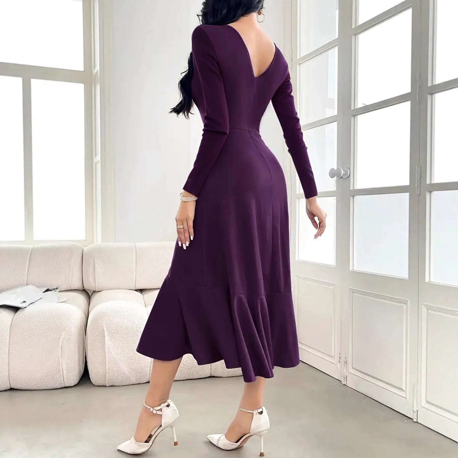 Purple women's long sleeve dress with round neck, mid waist, and ruffle detailing on a hanger.