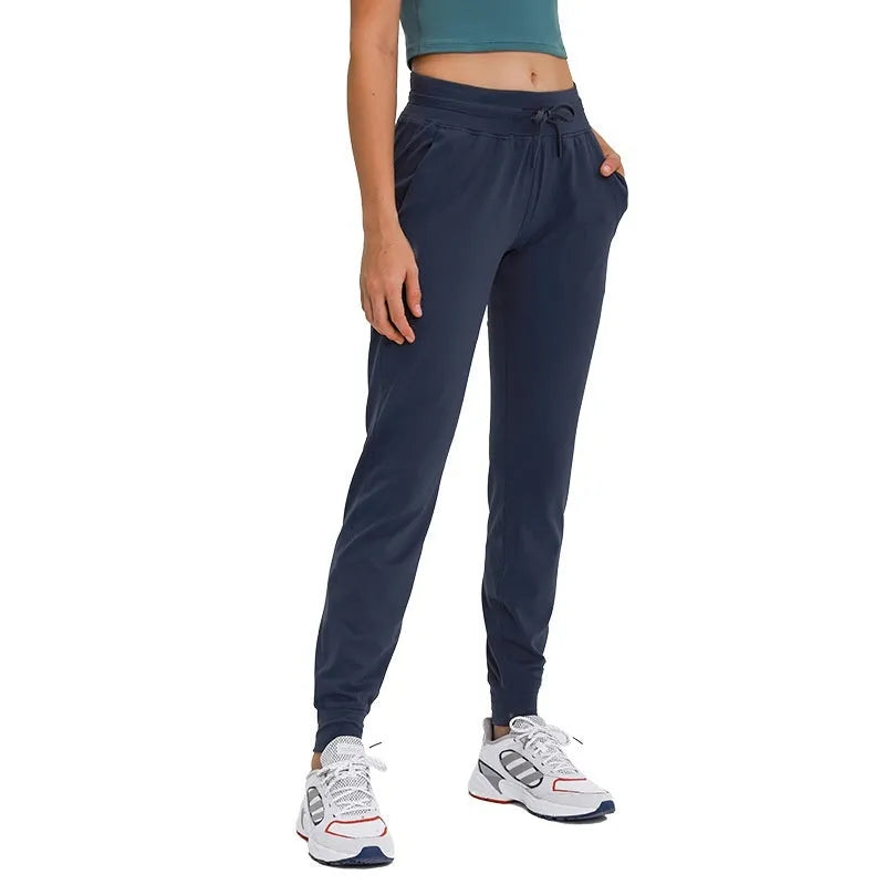 Women's high-waisted yoga pants with a drawstring waistband in a cotton blend fabric.