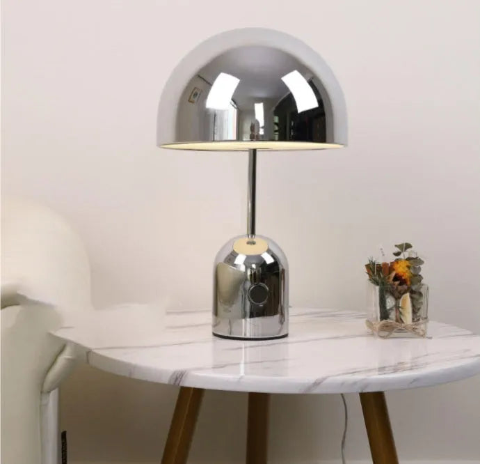Mushroom-shaped table lamp with metal base in chrome, gold, or rose gold finish on wooden table