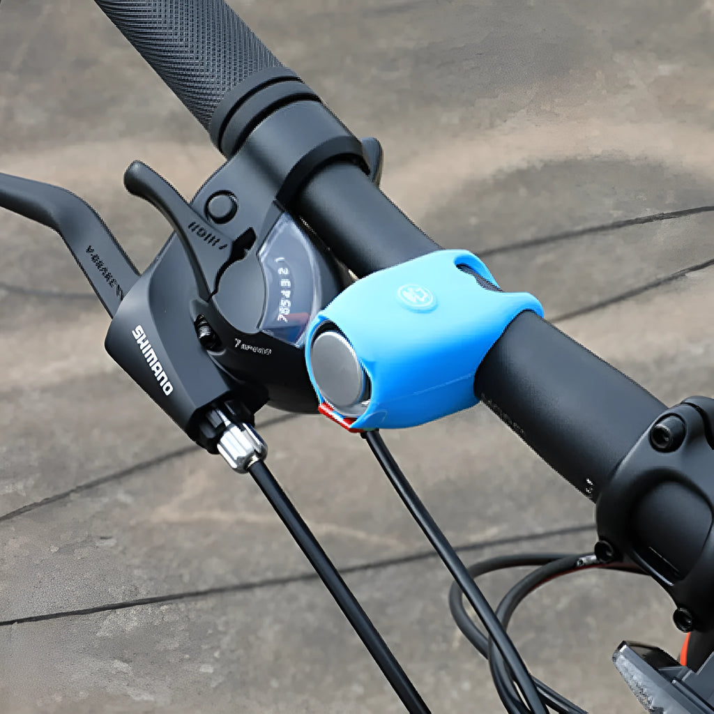 A plastic electronic bicycle horn in one of six colours, showing its compact shape for handlebar mounting.