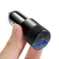 Aluminium alloy twin USB car charger shown in black, plugged into a car dashboard 12V socket.