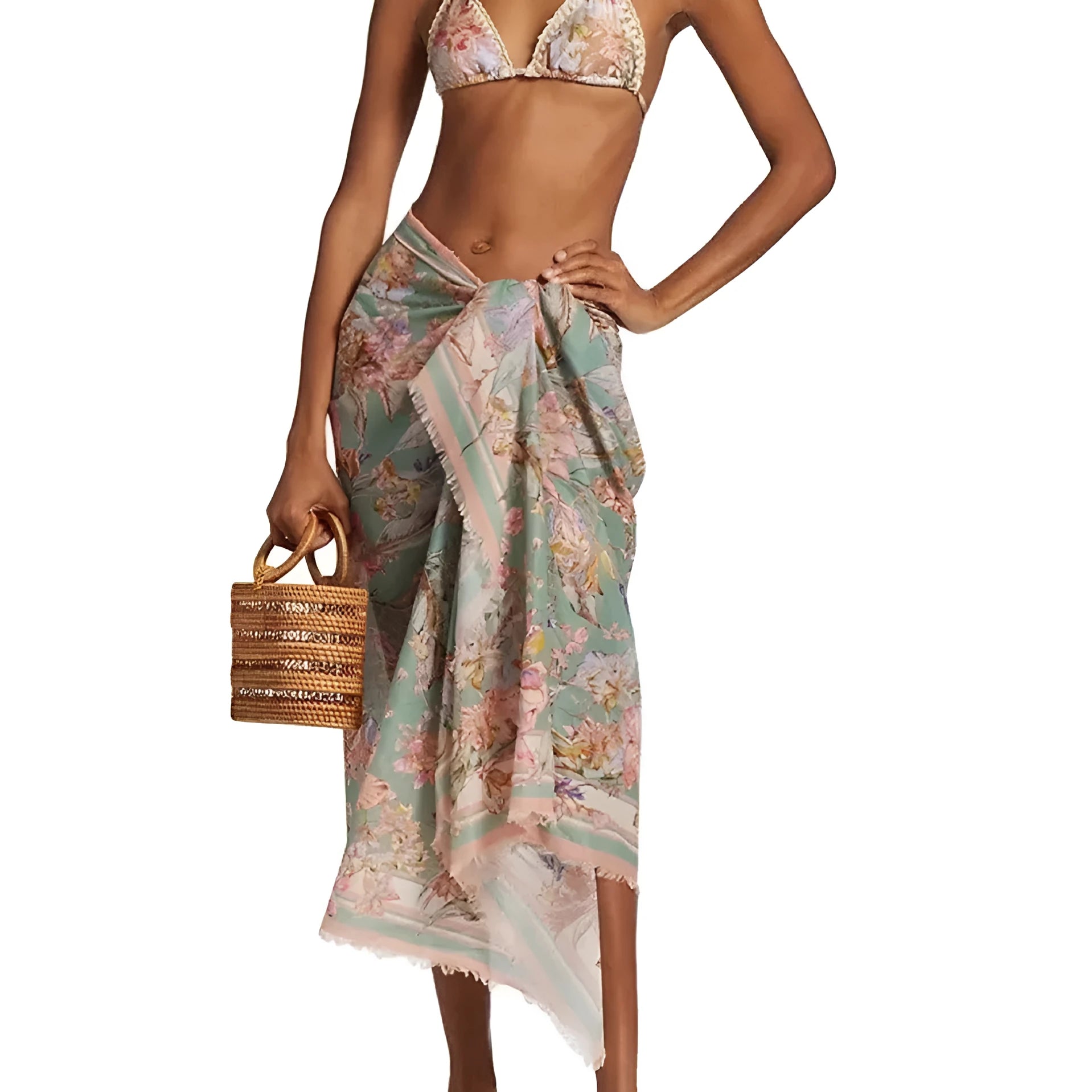 Women's creamy white floral bikini set with top, briefs, and removable skirt on beach background