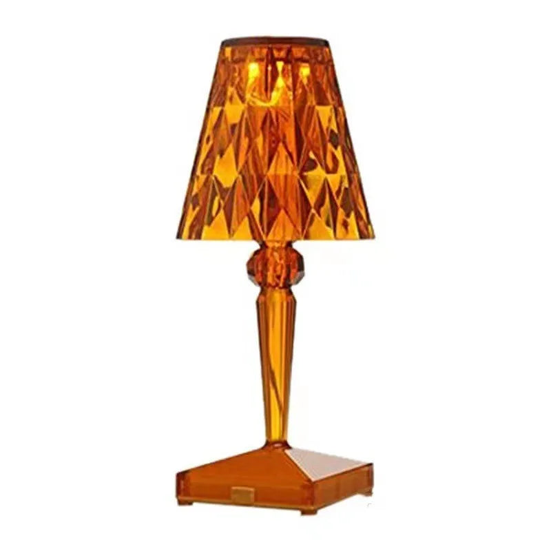 Rose gold portable touch projection night light with dimming controls on acrylic base.