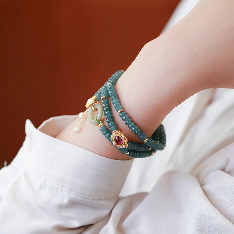 Blue water abacus and jade bead bracelet with tourmaline pearls in a three-ring design.