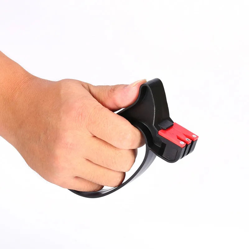 Black handheld knife and scissor sharpener with ergonomic grip on white background